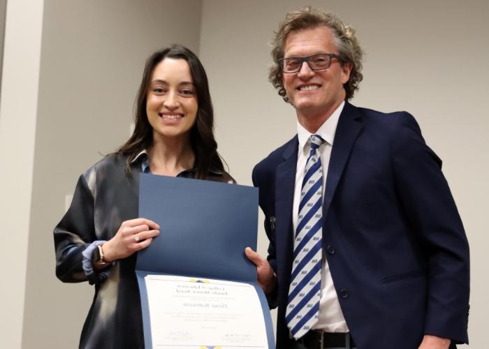 Man presenting woman with an award.